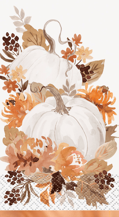 Two stacked white pumpkins surrounded by autumn foliage in orange, brown, and tan tones with copper foil accents on a white napkin.