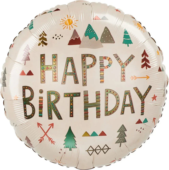 Round cream-colored mylar balloon with "HAPPY BIRTHDAY" in decorative patterned letters surrounded by illustrated trees, mountains, arrows, sun, and geometric designs in green, red, brown, and gold tones.