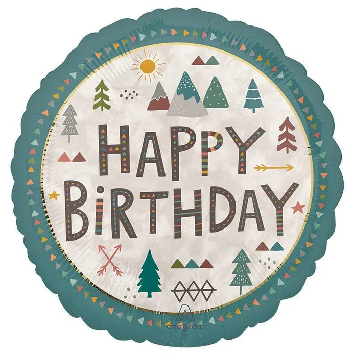 Teal scalloped round foil balloon with "HAPPY BIRTHDAY" text in brown letters surrounded by forest-themed decorations including evergreen trees, sun, stars, and triangular patterns in earth tones and gold.