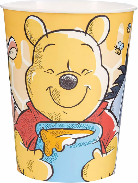 Yellow plastic cup featuring Winnie the Pooh character with a smiling face, wearing a red shirt and holding a blue honey pot, surrounded by bees and foliage on a yellow background.