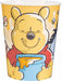 Yellow plastic cup featuring Winnie the Pooh character with a smiling face, wearing a red shirt and holding a blue honey pot, surrounded by bees and foliage on a yellow background.