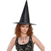 Black pointed witch hat with wide brim on a woman with curled reddish-brown hair wearing a black sequined top.