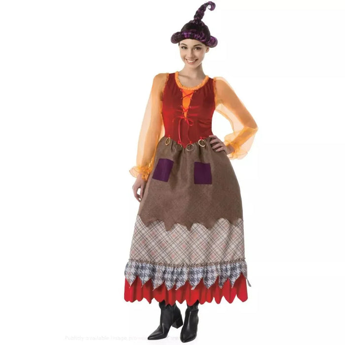 Woman wearing a colorful witch costume with a purple pointed hat, orange sheer sleeves, red velvet bodice, tan skirt with purple pockets, plaid and houndstooth pattern panels, and scalloped red hem with black boots.