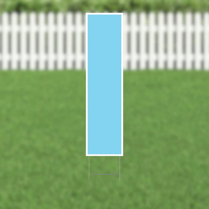 Light blue letter I yard sign with white border and metal ground stakes, displayed on grass in front of a white picket fence.
