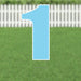 Light blue yard sign shaped like the number 1 with white border and metal stakes, displayed on a grass lawn with white picket fence in background.