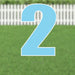 Large light blue number 2 yard sign with white outline and metal stakes, displayed on green grass with white picket fence background.