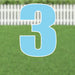 Large light blue number 3 yard sign with white outline and supporting stakes, displayed on green grass with a white picket fence background.