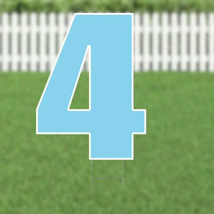 Large light blue number 4 yard sign with white border and metal stakes, displayed on green grass with white picket fence background.