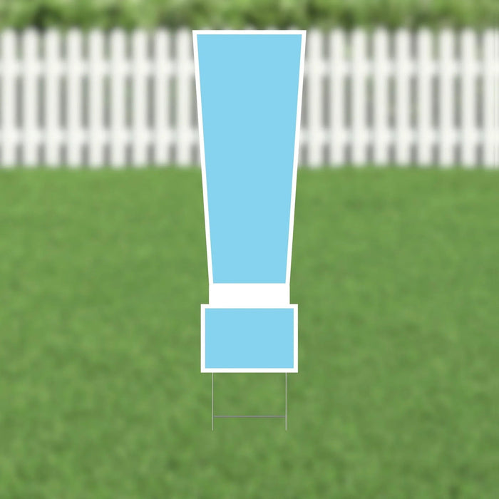 Light blue exclamation mark yard sign with white border and metal ground stakes, displayed on green grass with white picket fence background.