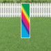 Tall rectangular yard card displaying a vibrant rainbow gradient that transitions from green at the top through yellow, orange, red, magenta, blue, and cyan, with a white border and metal stakes at the base.