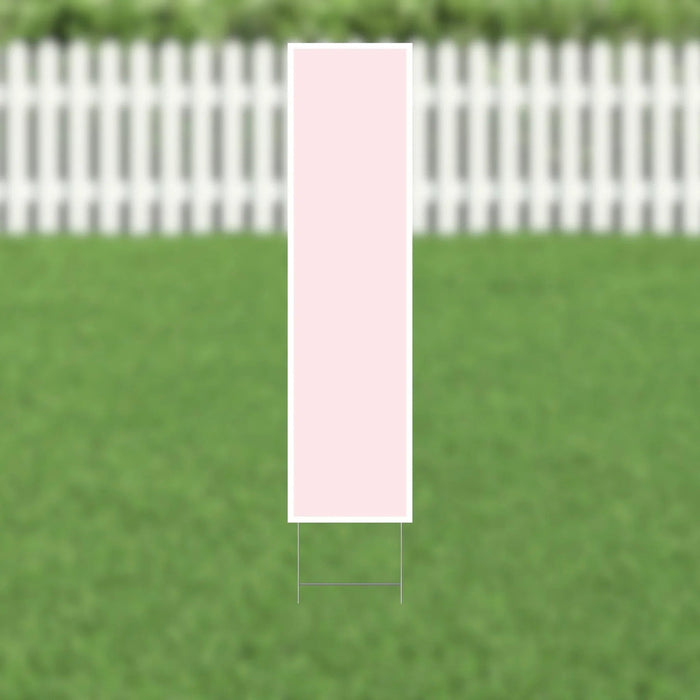 Pink rectangular yard card with the letter I displayed vertically, shown staked in a green lawn with a white picket fence in the background.