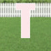 Pink letter T yard sign with white border and metal stakes, displayed on green grass with white picket fence in background.