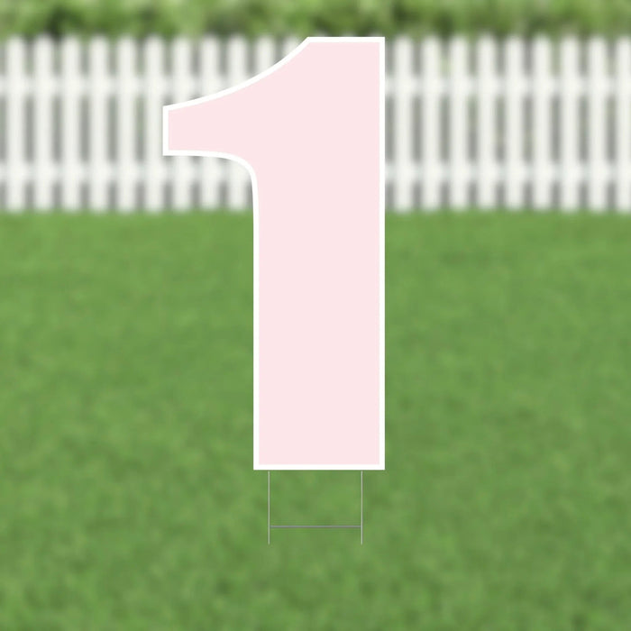 Light pink number 1 yard sign with white outline and metal stakes, displayed on green grass with white picket fence background.