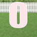 Large pink yard sign shaped like the number zero with white border and metal stakes, displayed on green grass with white picket fence background.