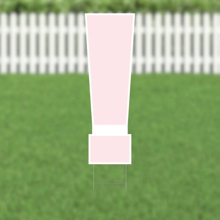 Pink exclamation mark yard sign with white border and metal ground stakes, displayed on a lawn with white picket fence in background.