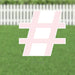 Pink and white hashtag symbol yard sign with metal stakes, displayed on a lawn with white picket fence background.