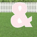 Pink ampersand symbol yard sign with white cutout details, displayed on green grass with white picket fence background.