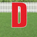 Red letter D yard sign with white outline and stakes, displayed on green grass with white picket fence background.