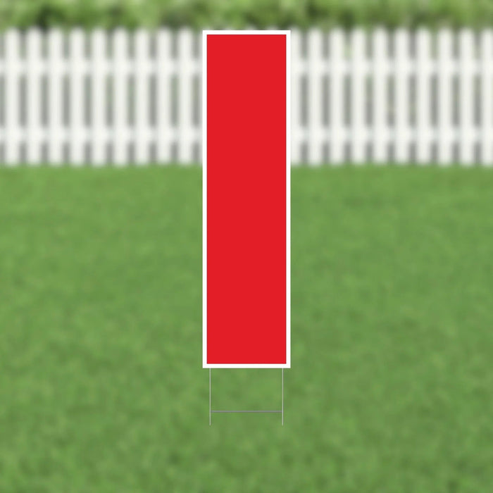 Red vertical rectangular yard card with white border and metal stakes, displayed on green lawn with white picket fence in background.