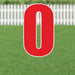 Red letter O yard sign with white border and metal stakes, displayed on a lawn with white picket fence in background.