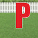 Red letter P yard sign with white outline and metal stakes, displayed on green grass with white fence background.