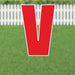 Red letter V yard sign with white border and metal stakes displayed on green grass with white picket fence in background.