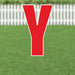 Red letter Y yard sign with white border and metal stake, displayed on green grass with white picket fence background.