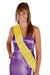 Woman wearing a purple sleeveless wrap dress with a yellow satin sash draped diagonally across the bodice.